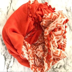 Orange & white patterned scarf with pom poms